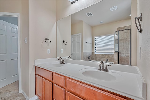 bathroom featuring vanity and a shower with shower door