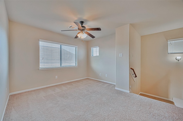 unfurnished room featuring light colored carpet and ceiling fan