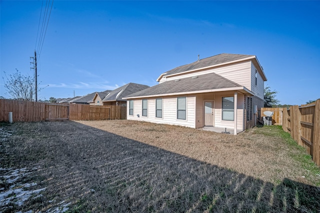 rear view of house with a yard