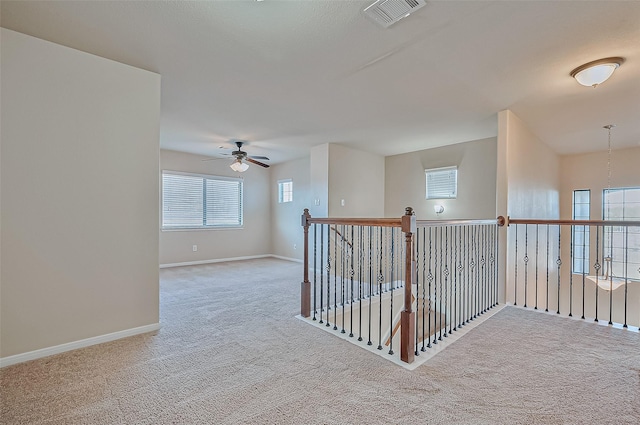 corridor with light colored carpet