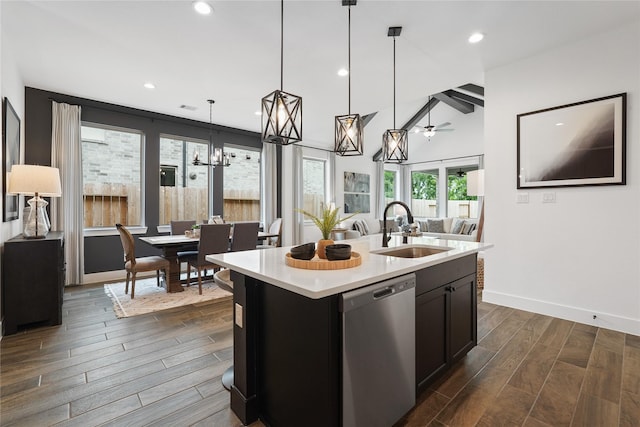 kitchen with a sink, light countertops, dishwasher, and wood finish floors