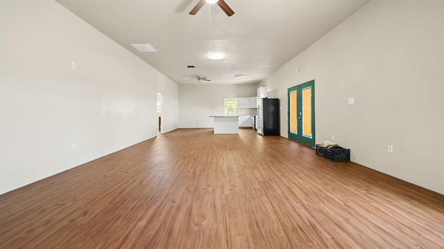 unfurnished living room featuring light hardwood / wood-style flooring and ceiling fan