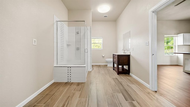 hallway with sink and light hardwood / wood-style floors