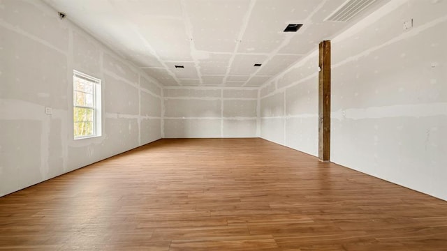 unfurnished room with hardwood / wood-style floors