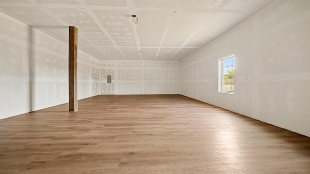 additional living space with hardwood / wood-style flooring