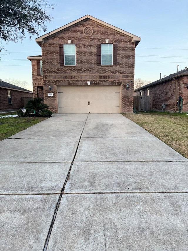 view of front of property featuring a garage and a front lawn