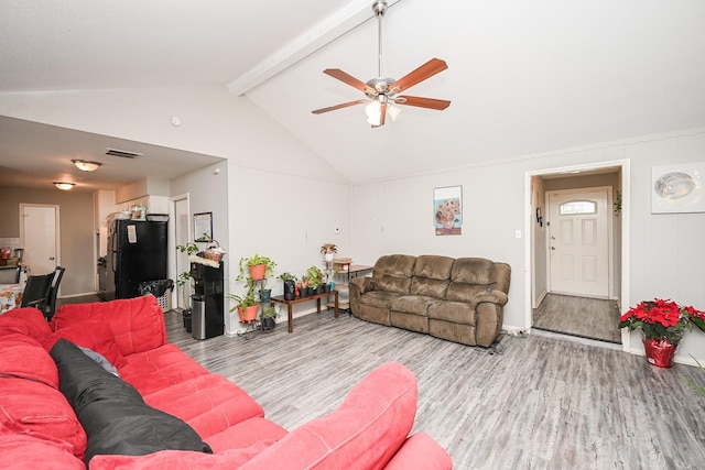 living room featuring lofted ceiling with beams, ceiling fan, and light wood-type flooring