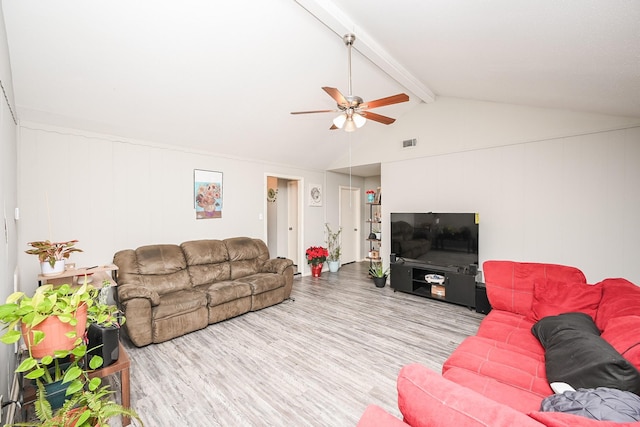 living room featuring ceiling fan, lofted ceiling with beams, and light wood-type flooring