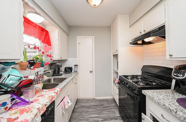 kitchen featuring black range with gas cooktop, sink, tasteful backsplash, light stone counters, and white cabinets