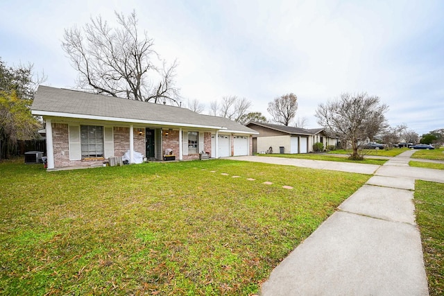 single story home with a porch, a garage, and a front lawn