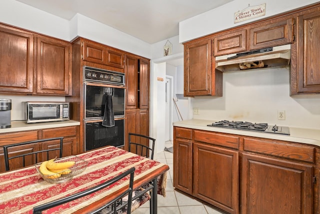 kitchen featuring appliances with stainless steel finishes and light tile patterned floors