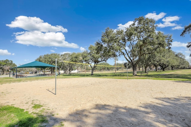 view of home's community featuring a lawn and volleyball court