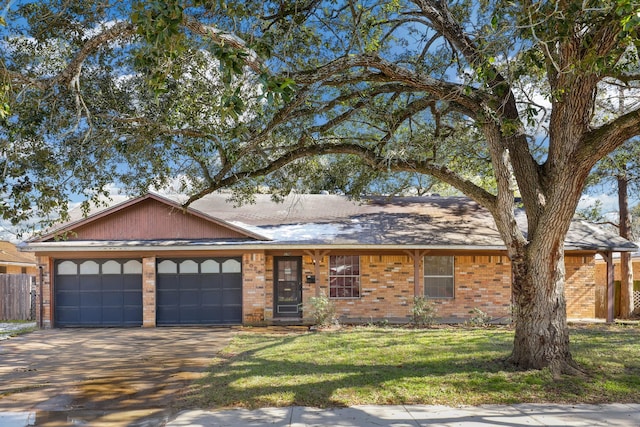 ranch-style house featuring a garage and a front lawn