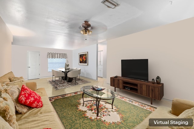 living room featuring ceiling fan and tile patterned floors