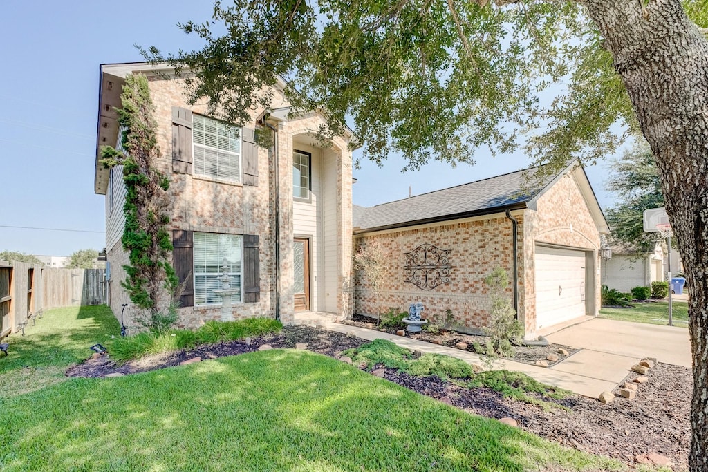 view of front of property featuring a garage and a front lawn