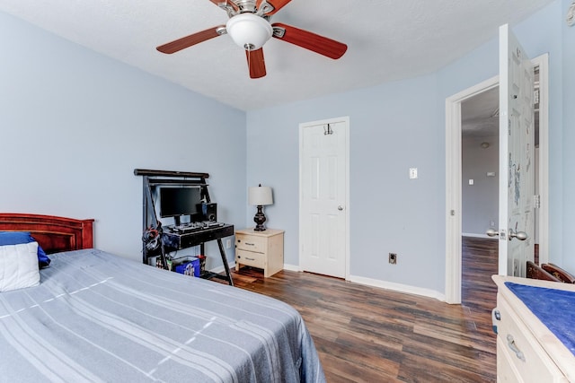 bedroom featuring ceiling fan, dark hardwood / wood-style flooring, and a textured ceiling