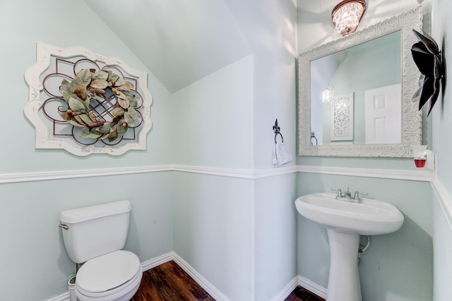 bathroom featuring hardwood / wood-style flooring, lofted ceiling, and toilet