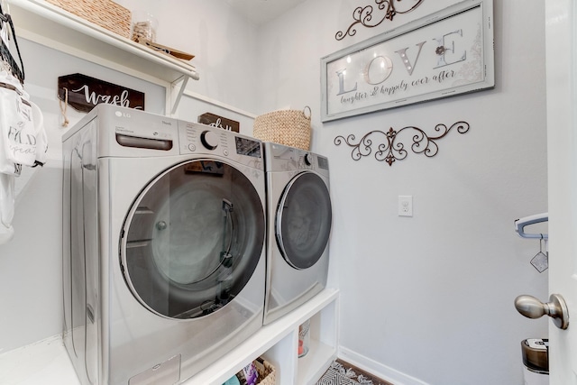 clothes washing area with washing machine and dryer