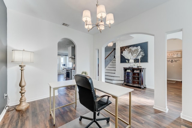 office space featuring an inviting chandelier and hardwood / wood-style floors