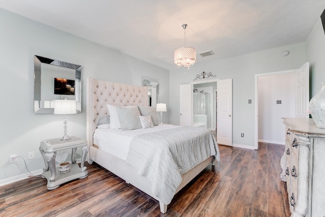 bedroom with an inviting chandelier and dark hardwood / wood-style floors