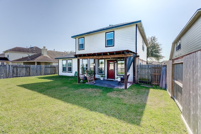 rear view of property featuring a patio area and a lawn