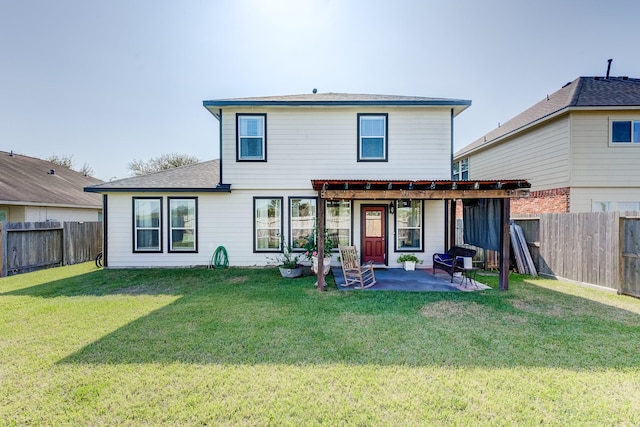 rear view of house with a yard and a patio area