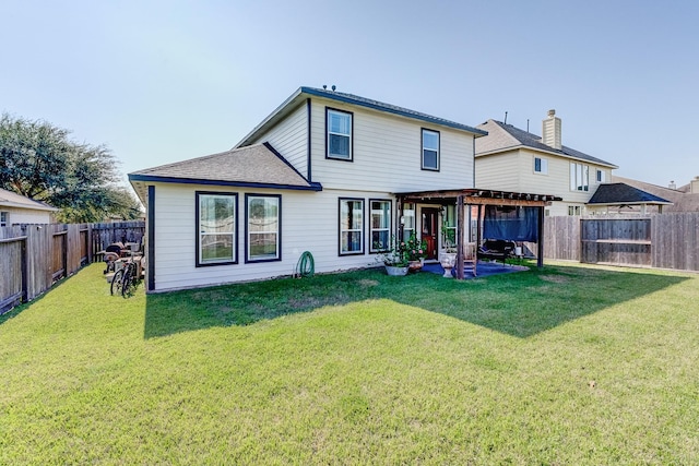 rear view of property featuring a yard and a patio