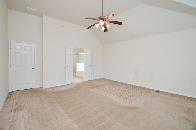 spare room featuring light carpet, high vaulted ceiling, and ceiling fan