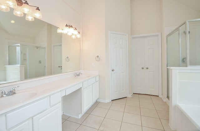 bathroom with an enclosed shower, vanity, tile patterned flooring, and vaulted ceiling