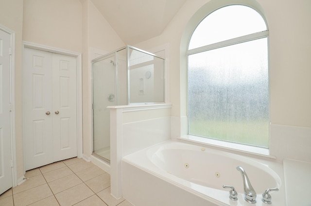 bathroom with tile patterned floors, separate shower and tub, and vaulted ceiling