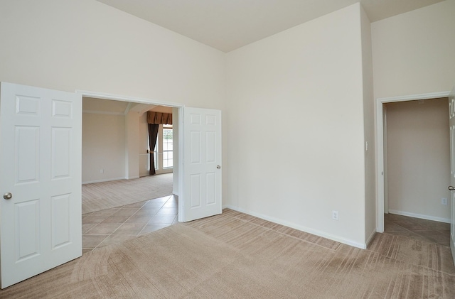 spare room featuring light carpet