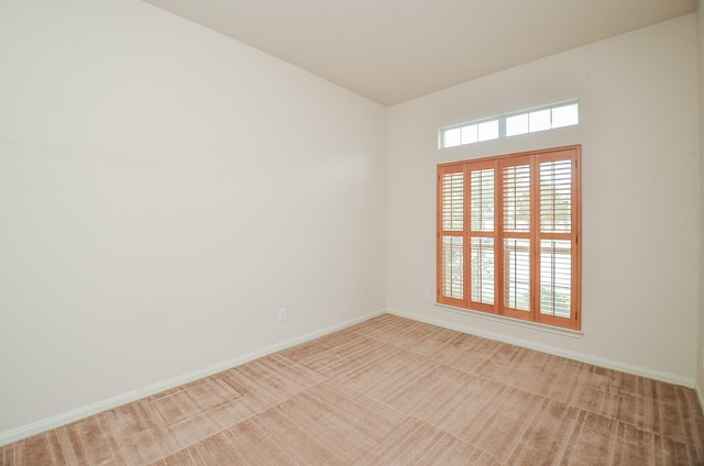 unfurnished room with light carpet