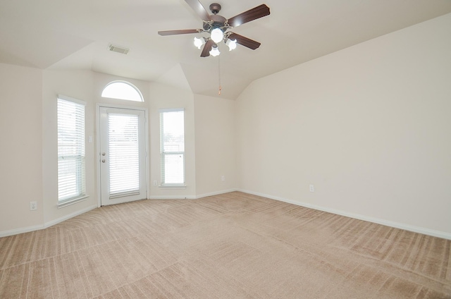 carpeted empty room with lofted ceiling, a wealth of natural light, and ceiling fan