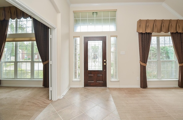 tiled foyer entrance featuring ornamental molding