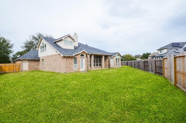 back of property featuring a lawn