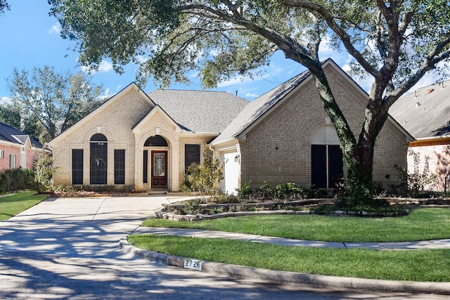 view of front of home featuring a garage and a front lawn