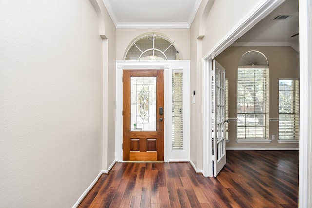 entrance foyer featuring ornamental molding and dark hardwood / wood-style flooring