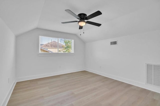 additional living space featuring vaulted ceiling, light hardwood / wood-style floors, and ceiling fan