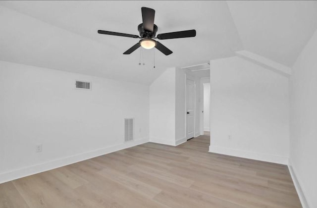 additional living space with light hardwood / wood-style flooring, ceiling fan, and vaulted ceiling