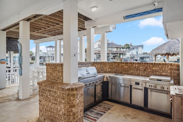 view of patio featuring a grill, exterior bar, and area for grilling