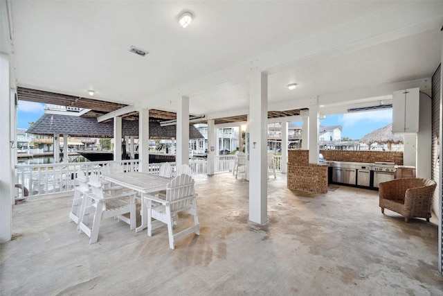 view of patio / terrace with a water view and area for grilling