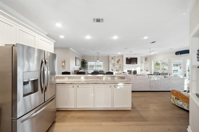 kitchen with stainless steel refrigerator with ice dispenser, light hardwood / wood-style flooring, ornamental molding, ceiling fan, and white cabinets