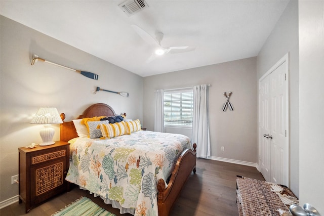 bedroom with dark hardwood / wood-style floors and ceiling fan