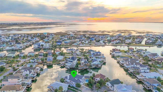 aerial view at dusk with a water view