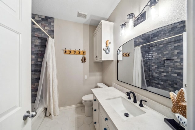 bathroom featuring tile patterned floors, toilet, vanity, and a textured ceiling