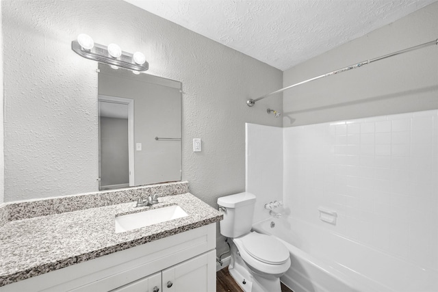 full bathroom with vanity, shower / washtub combination, a textured ceiling, and toilet