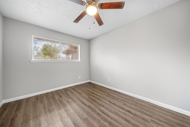 empty room with hardwood / wood-style flooring, ceiling fan, and a textured ceiling