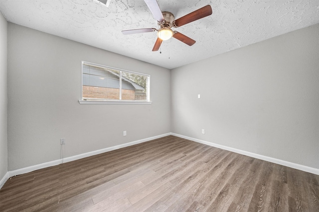 empty room featuring hardwood / wood-style flooring, ceiling fan, and a textured ceiling