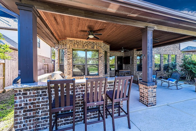 view of patio / terrace featuring an outdoor kitchen and ceiling fan