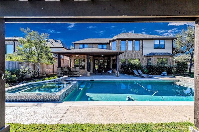 view of swimming pool with a patio and an in ground hot tub